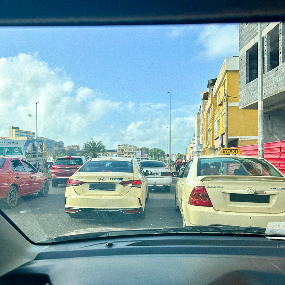 Traffic seen through a car windshield on a Cape Verde street.